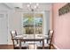 Dining room with hardwood floors, chandelier, and slider door, creating a warm atmosphere at 8738 Chase Dr # 133, Arvada, CO 80003