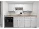 This well-lit kitchen shows matching black appliances against white cabinets and granite countertops at 8738 Chase Dr # 133, Arvada, CO 80003