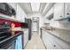 Efficient galley kitchen with white cabinets, granite countertops, and modern appliances at 8738 Chase Dr # 133, Arvada, CO 80003