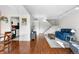 Spacious living room with hardwood floors, bright staircase, and open layout at 8738 Chase Dr # 133, Arvada, CO 80003