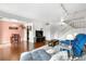 Bright living room featuring stylish furnishings, hardwood floors, and an open staircase at 8738 Chase Dr # 133, Arvada, CO 80003