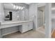 Bathroom featuring a sink, cabinets, large mirror, and a walk-in shower with glass door at 7900 W Layton Ave # 864, Littleton, CO 80123