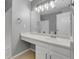 Bathroom with large mirror, vanity area, and a shower/bath combo in white at 7900 W Layton Ave # 864, Littleton, CO 80123