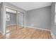 Bedroom showcasing a mirrored sliding closet door and wood-look flooring at 7900 W Layton Ave # 864, Littleton, CO 80123