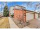 Charming townhouse with a brick facade, two-car garage, and well-kept landscaping at 7900 W Layton Ave # 864, Littleton, CO 80123