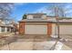 Two-car garage with brick trim and concrete driveway on a sunny day at 7900 W Layton Ave # 864, Littleton, CO 80123