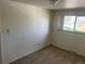 Cozy bedroom featuring neutral carpet, light walls, and a window offering natural light at 4505 Everett St, Wheat Ridge, CO 80033