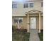 Inviting townhouse exterior with brick facade and covered porch entrance at 4505 Everett St, Wheat Ridge, CO 80033