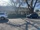 Modest townhome exterior with neutral siding, mature trees, and visible front parking on a sunny day at 4505 Everett St, Wheat Ridge, CO 80033