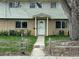 Charming townhome featuring a secure white screen door and a covered entrance, enhancing curb appeal at 4505 Everett St, Wheat Ridge, CO 80033
