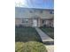 Classic townhome showcases a welcoming entrance with a walkway leading to the front door, adding charm at 4505 Everett St, Wheat Ridge, CO 80033