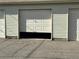 Partially open garage door at 4505 Everett St, Wheat Ridge, CO 80033
