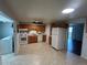 Bright kitchen features tile floors, stainless steel appliances, and oak cabinets at 4505 Everett St, Wheat Ridge, CO 80033