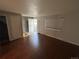 Living room with hardwood floors leading to a tiled entry and staircase at 4505 Everett St, Wheat Ridge, CO 80033