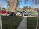 A view outside, showing a tree and several cars through a wooden fence at 4505 Everett St, Wheat Ridge, CO 80033