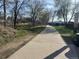 Neighborhood walking path with trees and park signage on a sunny day at 4505 Everett St, Wheat Ridge, CO 80033