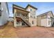 A view of the back exterior of the home with a wooden deck and steps leading to the backyard at 8840 Whiteclover St, Littleton, CO 80125