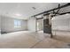 Unfinished basement with concrete floors and a sliding glass door at 8840 Whiteclover St, Littleton, CO 80125