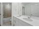 This bathroom features a double sink vanity, tile floors, and tiled shower at 8840 Whiteclover St, Littleton, CO 80125