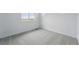 This carpeted bedroom has bright white walls and a large window for natural light at 8840 Whiteclover St, Littleton, CO 80125