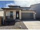 Beautiful two-story home with stone accents, a covered porch and a gray two-car garage at 8840 Whiteclover St, Littleton, CO 80125