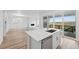 Bright kitchen island with stainless dishwasher, sink, and large sliding glass doors leading to an outdoor deck at 8840 Whiteclover St, Littleton, CO 80125