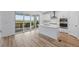 Modern kitchen with white cabinets, stainless steel appliances, and a large island at 8840 Whiteclover St, Littleton, CO 80125