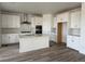 Bright kitchen with white cabinets, stainless steel appliances, an island and wood flooring at 8840 Whiteclover St, Littleton, CO 80125