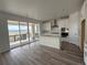 Bright kitchen with white cabinets, an island and stainless steel appliances, with an open view to the back patio at 8840 Whiteclover St, Littleton, CO 80125