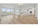 Open-concept living room and kitchen, featuring hardwood floors and plenty of natural light at 8840 Whiteclover St, Littleton, CO 80125