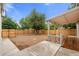 Large backyard with a wood fence, big mature tree, stone landscaping feature, and covered deck area at 3287 S Humboldt St, Englewood, CO 80113