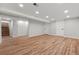 Finished basement with wood floors and white doors and trim at 3287 S Humboldt St, Englewood, CO 80113