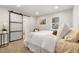 Cozy bedroom with sliding barn door, neutral decor, and a large window for ample natural light at 3287 S Humboldt St, Englewood, CO 80113