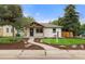 Charming home featuring a well-manicured lawn, welcoming walkway, and modern exterior design at 3287 S Humboldt St, Englewood, CO 80113