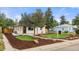 Home's inviting exterior, featuring a well-kept lawn, mulch accents, and a charming walkway at 3287 S Humboldt St, Englewood, CO 80113