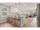 Bright kitchen featuring a breakfast bar with seating, modern lighting, and an adjacent dining area at 3287 S Humboldt St, Englewood, CO 80113