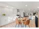 Open-concept kitchen showcases white cabinets, stainless steel appliances, breakfast bar, and adjacent dining area at 3287 S Humboldt St, Englewood, CO 80113