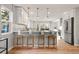 Modern kitchen with a breakfast bar, pendant lighting, and stainless steel appliances at 3287 S Humboldt St, Englewood, CO 80113
