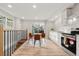 Bright kitchen features stainless steel appliances, white cabinets, and a cozy dining area with sliding glass door at 3287 S Humboldt St, Englewood, CO 80113