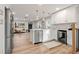 Well-designed kitchen with a breakfast bar, open layout and stainless-steel appliances overlooking living area at 3287 S Humboldt St, Englewood, CO 80113