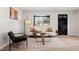 Comfortable living room featuring a large window, contemporary furnishings, and sleek hardwood floors at 3287 S Humboldt St, Englewood, CO 80113