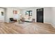 Cozy living room featuring light wood floors, a modern couch, and a black front door at 3287 S Humboldt St, Englewood, CO 80113