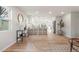 Bright, open concept living space with light hardwood floors seamlessly connecting to the modern kitchen at 3287 S Humboldt St, Englewood, CO 80113