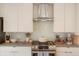 Modern kitchen with stainless steel range and backsplash at 1616 S Broadway # 217, Denver, CO 80210