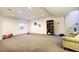 Finished basement with ample space, featuring neutral carpet, play area, and decorative shelving at 3003 S Sherman St, Englewood, CO 80113