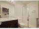 Modern bathroom featuring a glass-enclosed shower, dark wood vanity, and large mirror at 3003 S Sherman St, Englewood, CO 80113