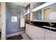 Modern bathroom featuring a glass-enclosed shower, double vanity, and sleek fixtures at 3003 S Sherman St, Englewood, CO 80113