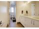 Bright bathroom featuring a double vanity, modern fixtures, and a walk-in shower at 3003 S Sherman St, Englewood, CO 80113