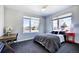Bright bedroom featuring large windows with view, desk area, comfortable bed, and modern decor at 3003 S Sherman St, Englewood, CO 80113