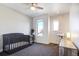 Bright Bedroom featuring a crib, changing table, and plenty of natural light, perfect for a new baby at 3003 S Sherman St, Englewood, CO 80113